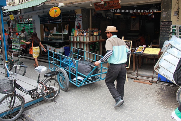 Luggage porter travelling through a narrow street on Koh Phi Phi Don