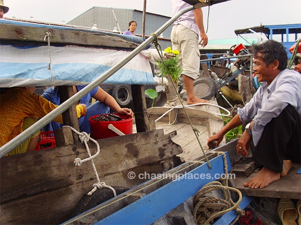 Locals having a laugh at the floating market near Can Tho, Vietnam