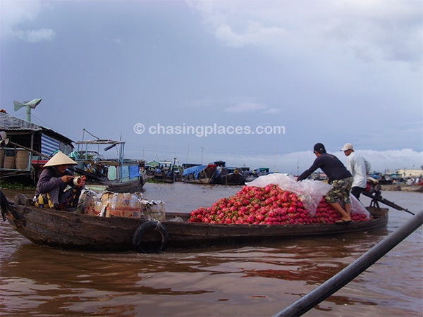 Some of the locals on the Mekong transporting a massive pile dragonfruit with rain looming in the background