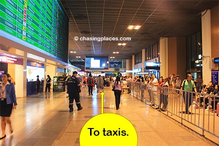 Walk past the rental car booths and tourist information desks to reach the taxi area