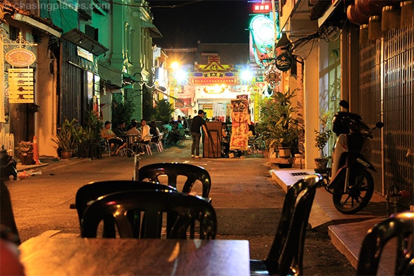  Locals drinking beside some aged shops in Melaka