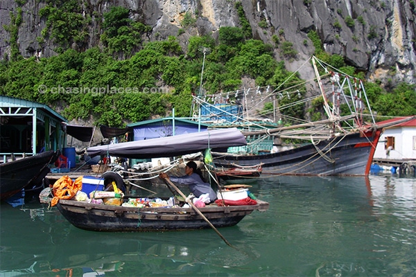 A local Vietnamese women rows near the fishing village