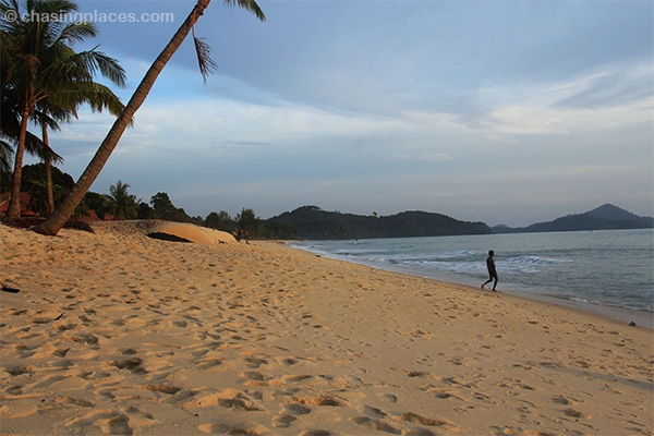 Sink into the deep honey-hued sand of Pantai Tengah