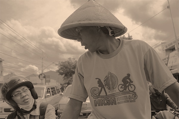 Our becak driver chats with a moto driver at a red light in Yogyakarta