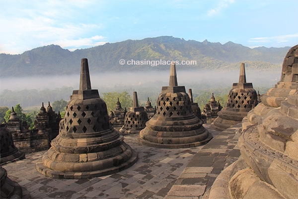 The morning mist rising over the surrounding mountain ridges at Borobudur.