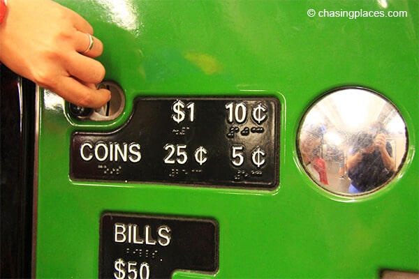 Placing coins in a New York Subway ticket machine